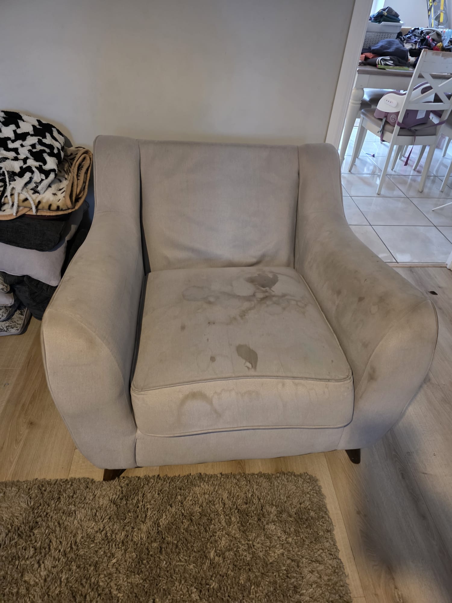 Stained armchair before professional upholstery cleaning treatment