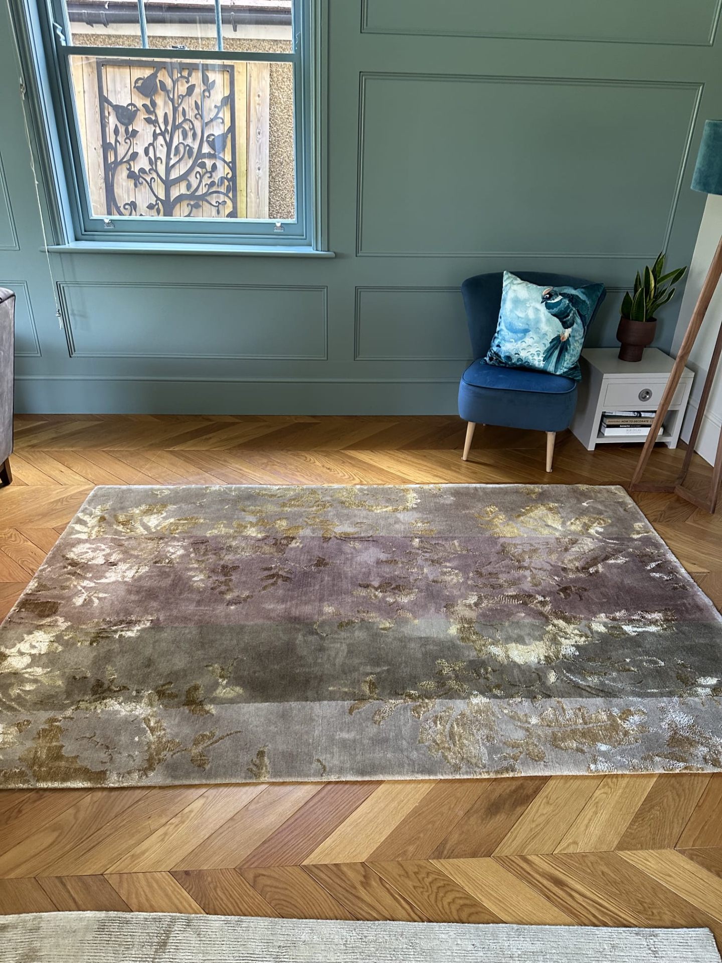 Luxury purple and gold rug professionally cleaned on herringbone floor