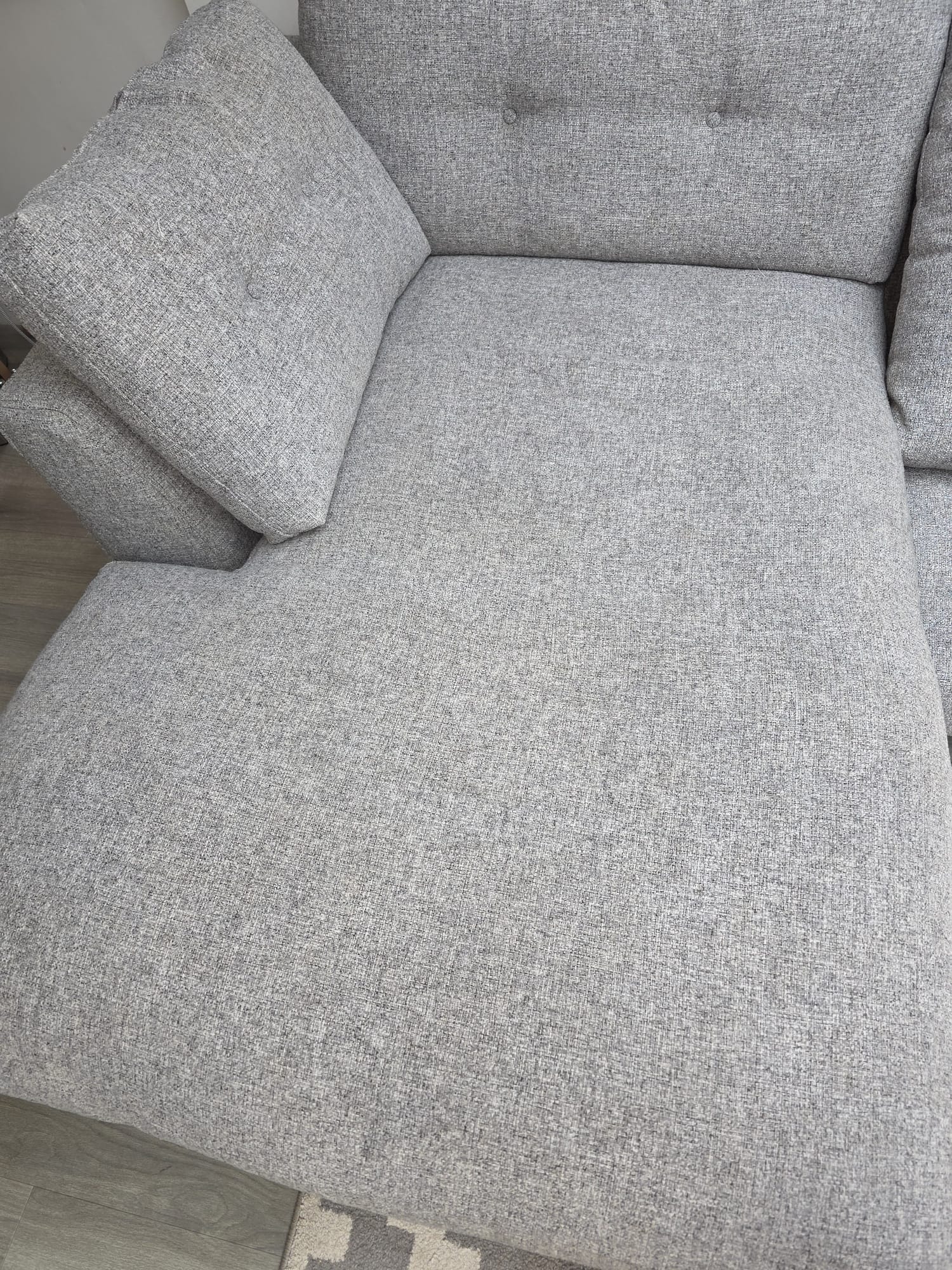Grey fabric sofa professionally cleaned with restored texture and colour